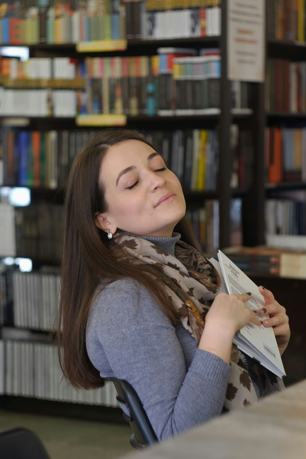 A girl showing she is thrilled with the book she has been reading